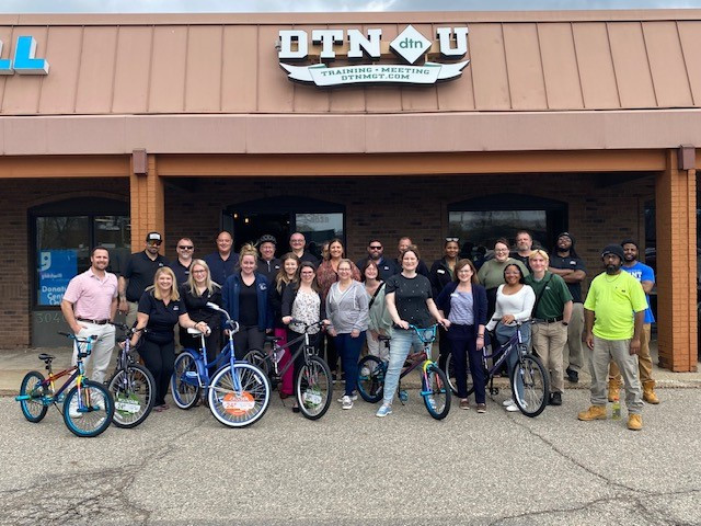 The DTN Team building bikes for donation to Boys and Girls Club of Lansing.