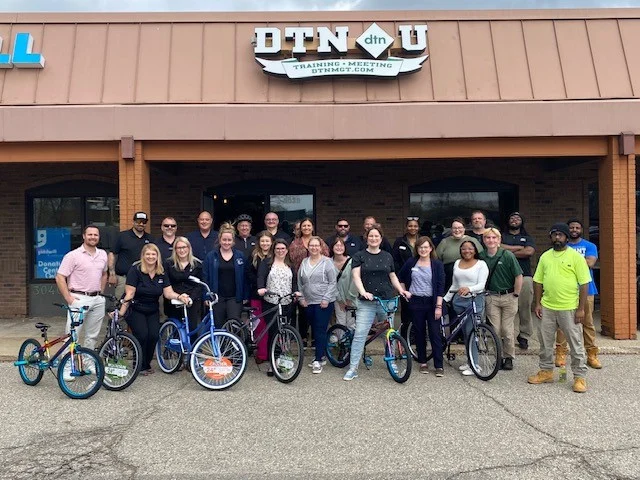 The DTN Team building bikes for donation to Boys and Girls Club of Lansing.