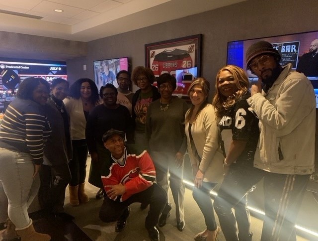 Staff members celebrate Black History Month and attend a Devil’s game in the firm suite at the Prudential Center.