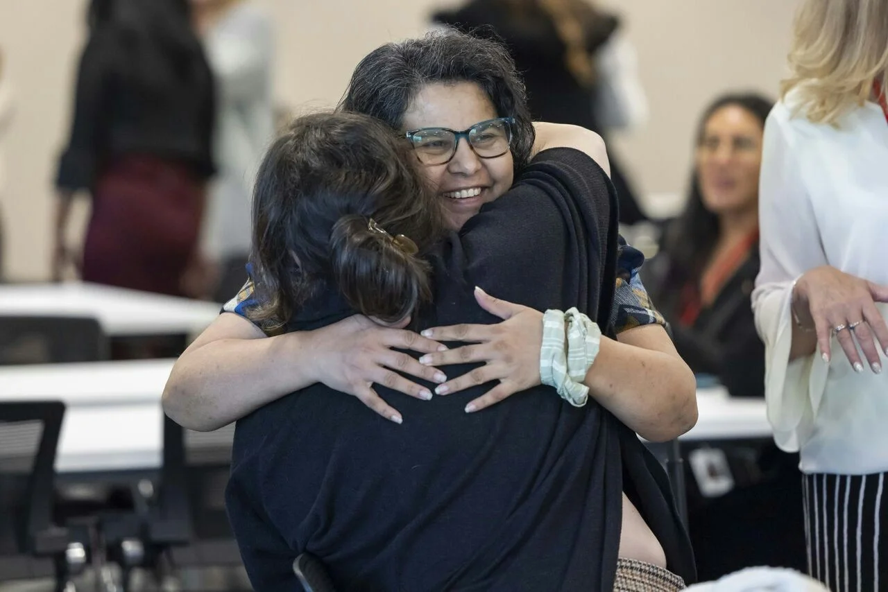 Paylocity employees embracing each other