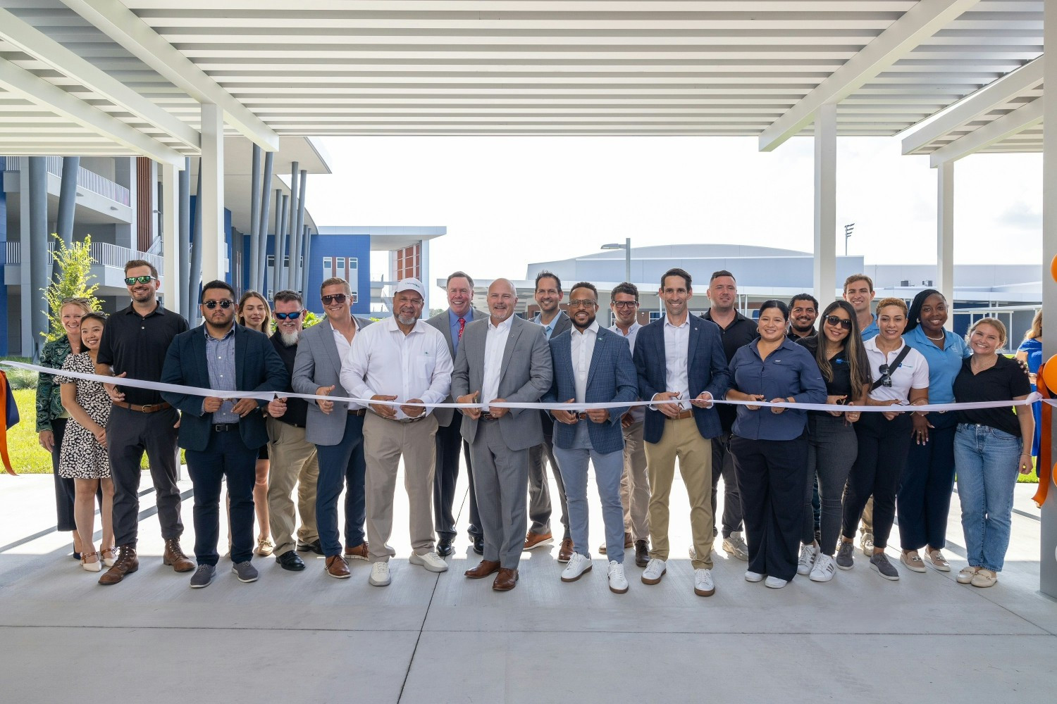 Celebrating together: the ribbon-cutting for Aquilla J. Morgan High School, serving students in a growing community.