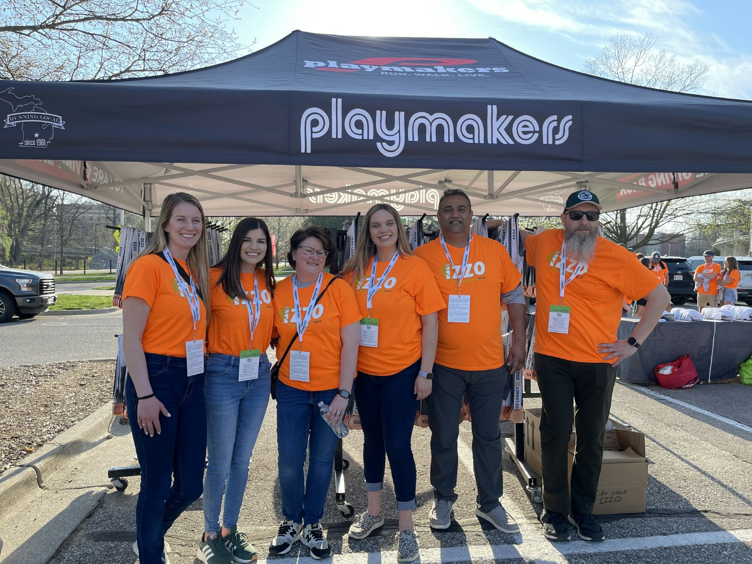 Employees volunteering at a local race to offer words of encouragement as they complete the course.