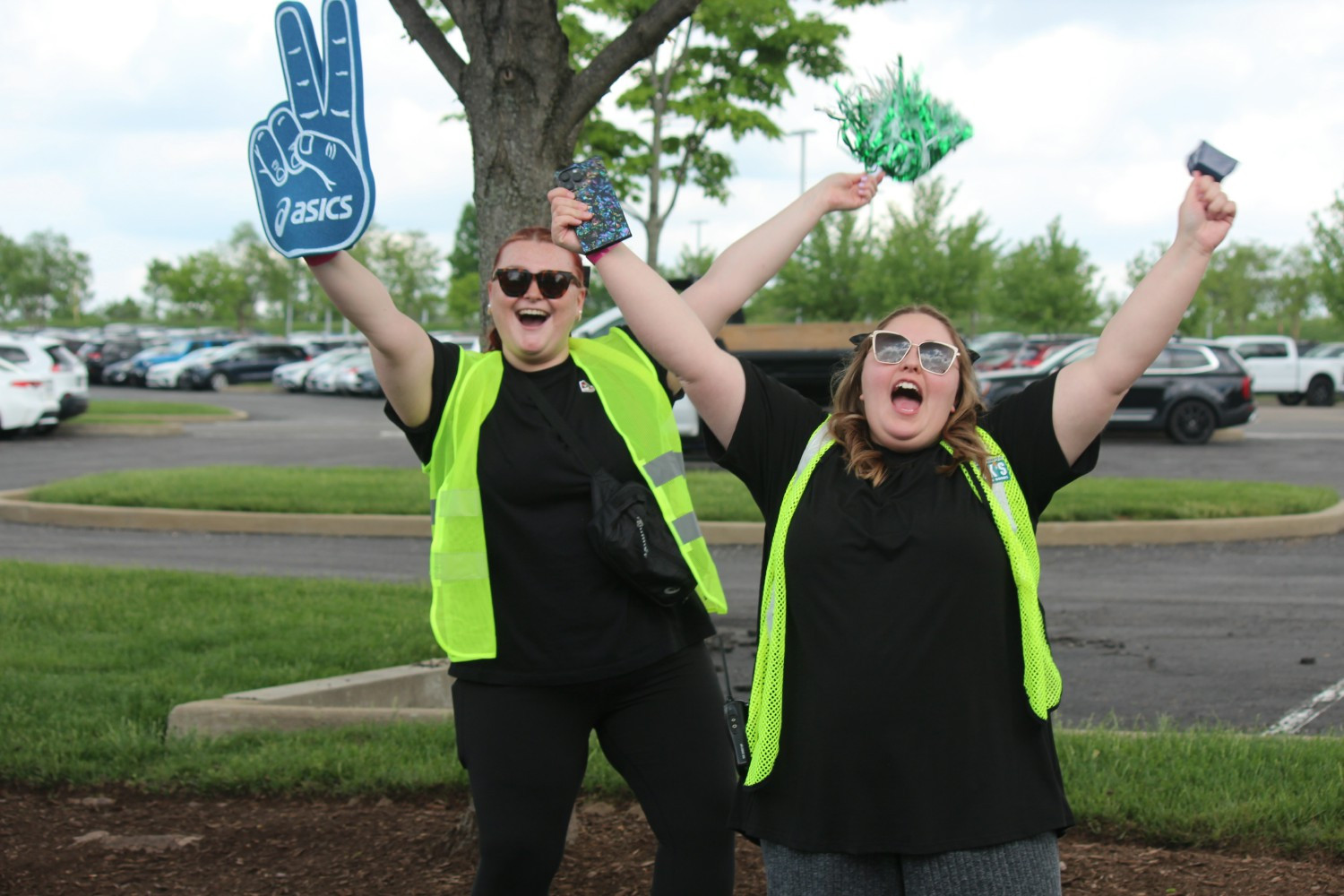 Teammates cheer on fun run participants at our annual ASICS fun run.