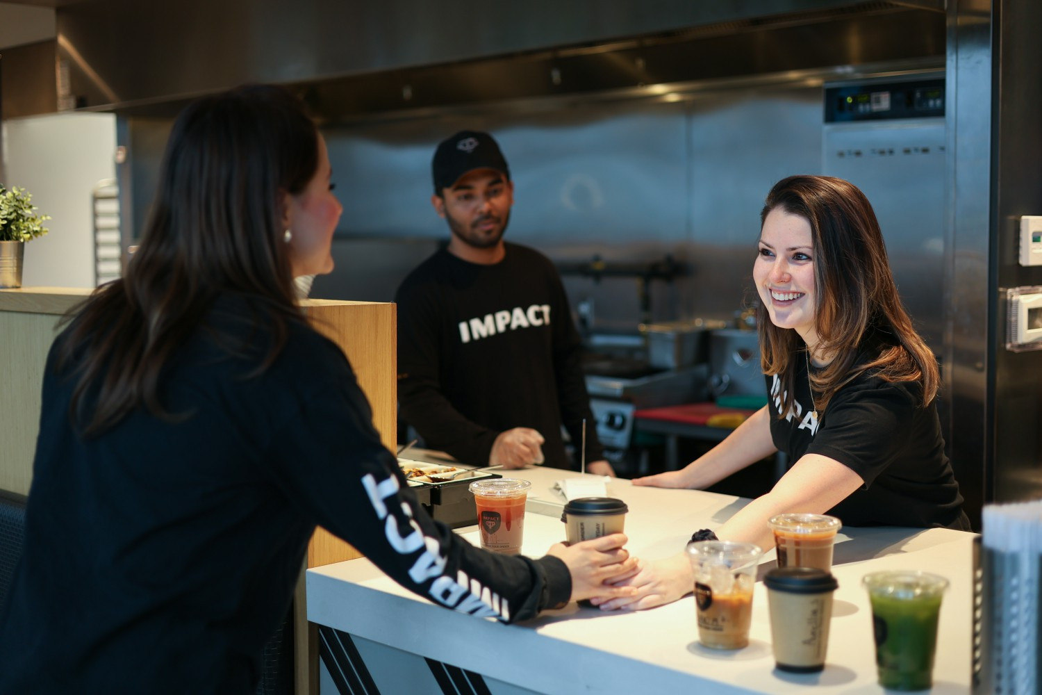 Manager hands over Coffee order to server
