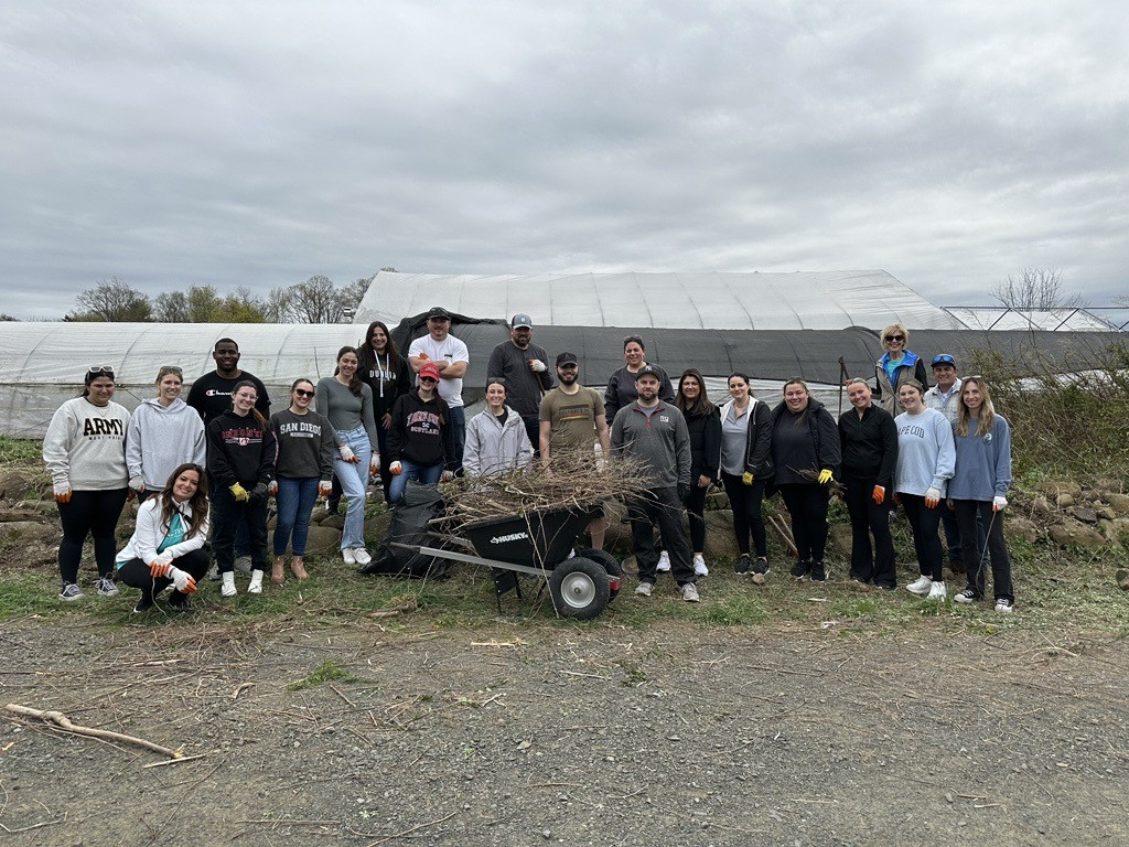 Earth Day volunteers at a local non-profit farm doing work on the fields.