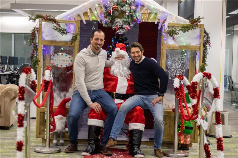 Our Co-Founders, Paul and Henry meeting santa at our in office Santa's grotto, giving presents to our teams children