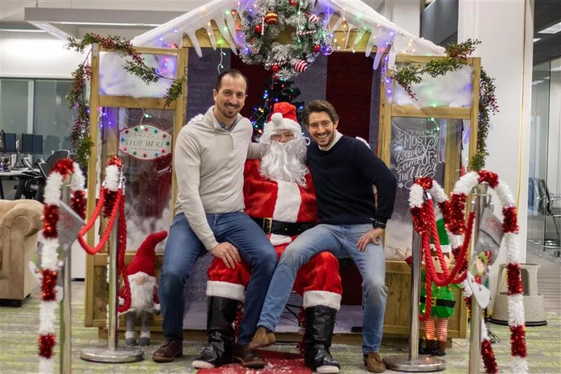 Our Co-Founders, Paul and Henry meeting santa at our in office Santa's grotto, giving presents to our teams children