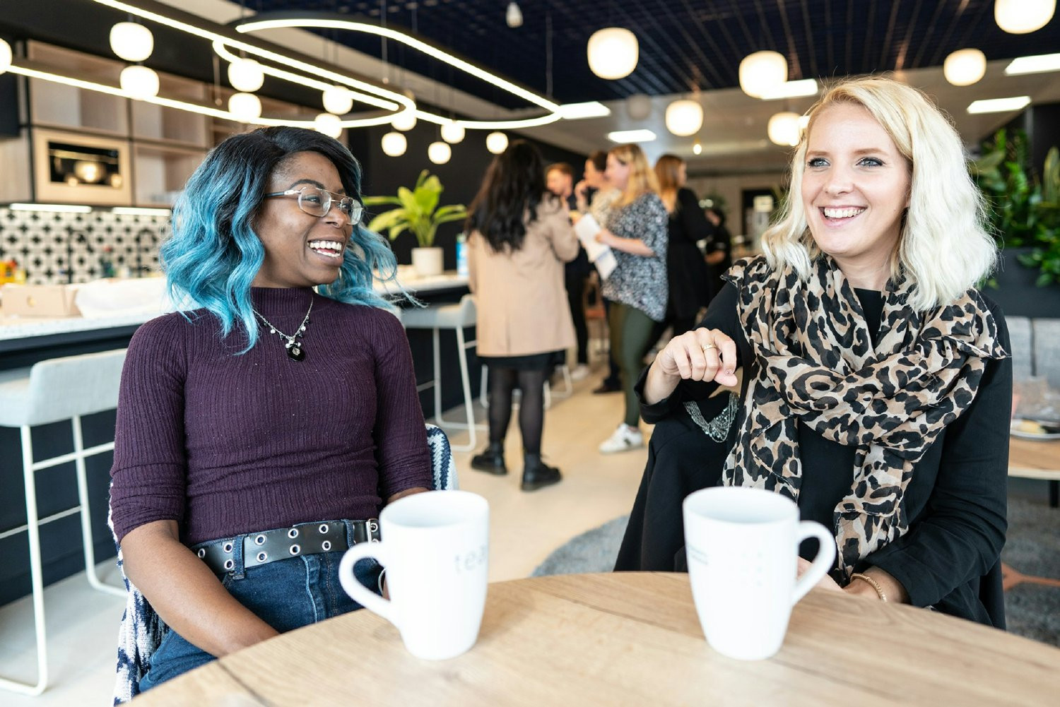 Colleagues enjoying a chat in our Wimbledon Headquarters.