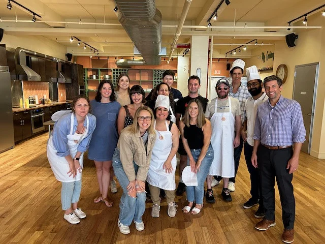 US teams at our NYC workshop: collaborating, learning, and building connections during a fun cooking session.