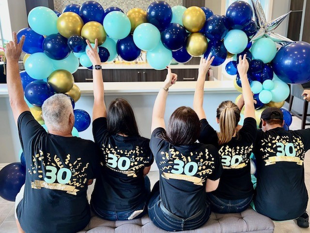 BH'ers honoring our company's 30th Anniversary with T-shirts and balloons.