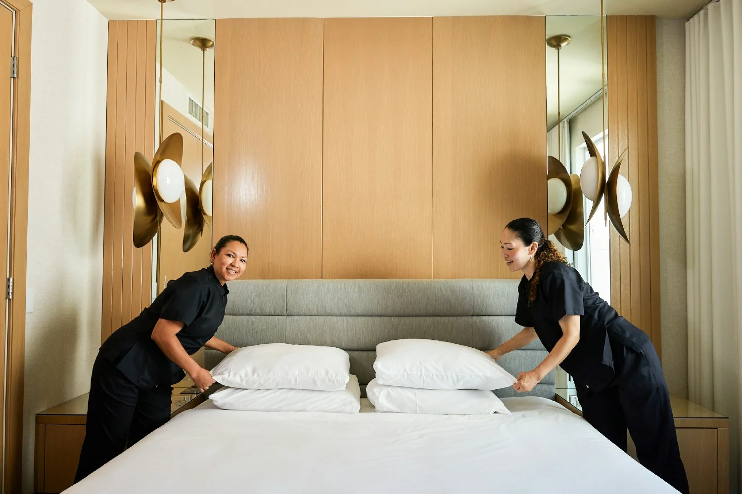 Two of our amazing IHG Room Attendants fluffing pillows and perfecting details. 