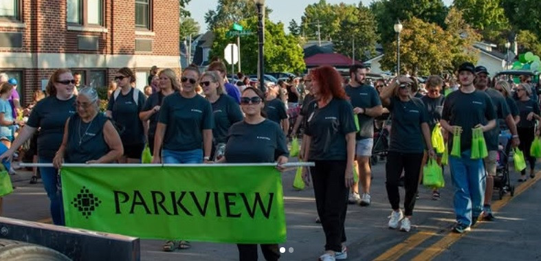 Parkview co-workers march in a local street fair parade in one of the communities we serve.