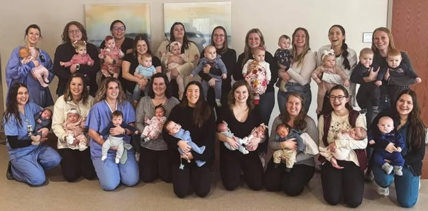 Parkview birthing center co-workers pose with their children during a