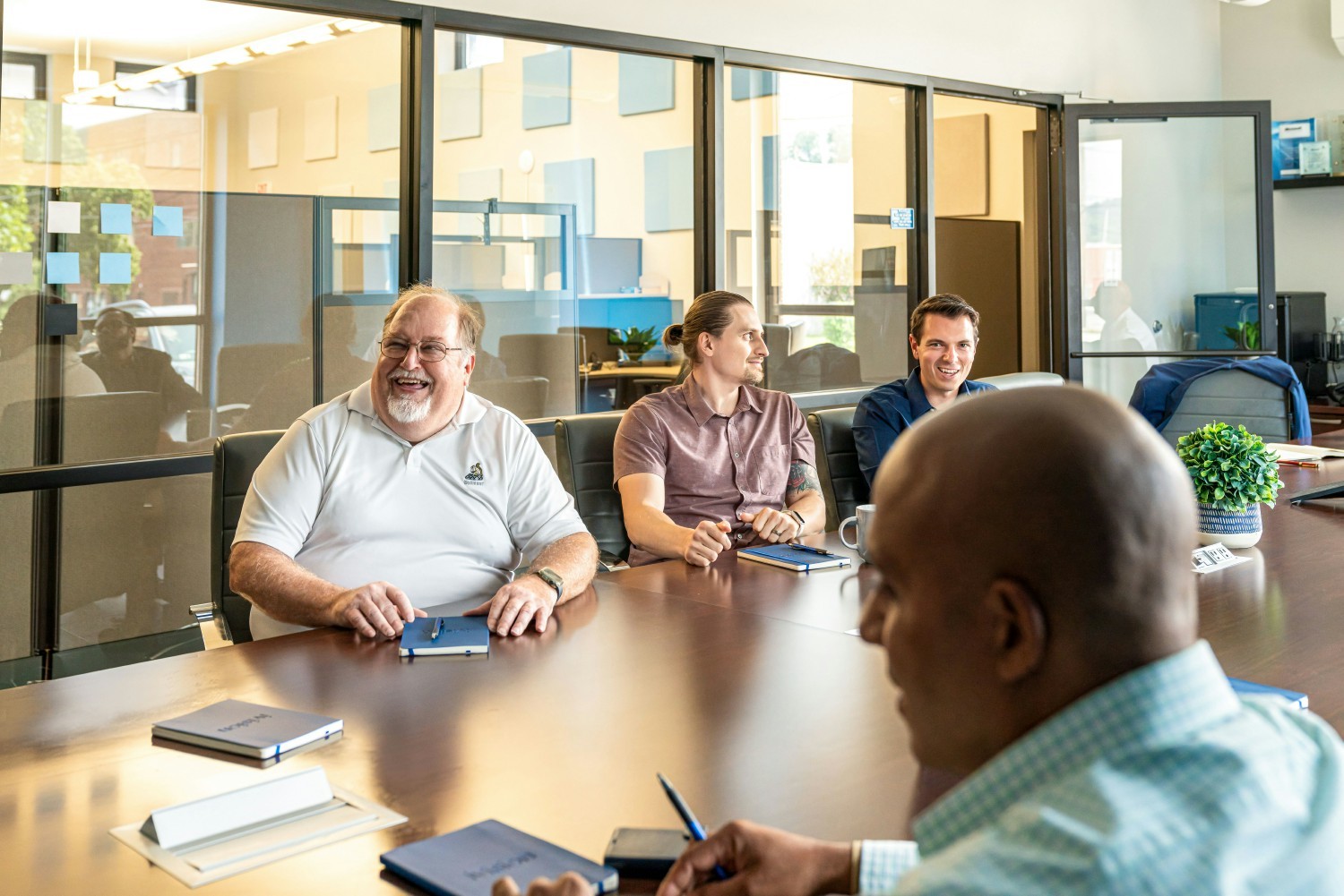 Team members laugh during an internal meeting at our Pittsburgh office.