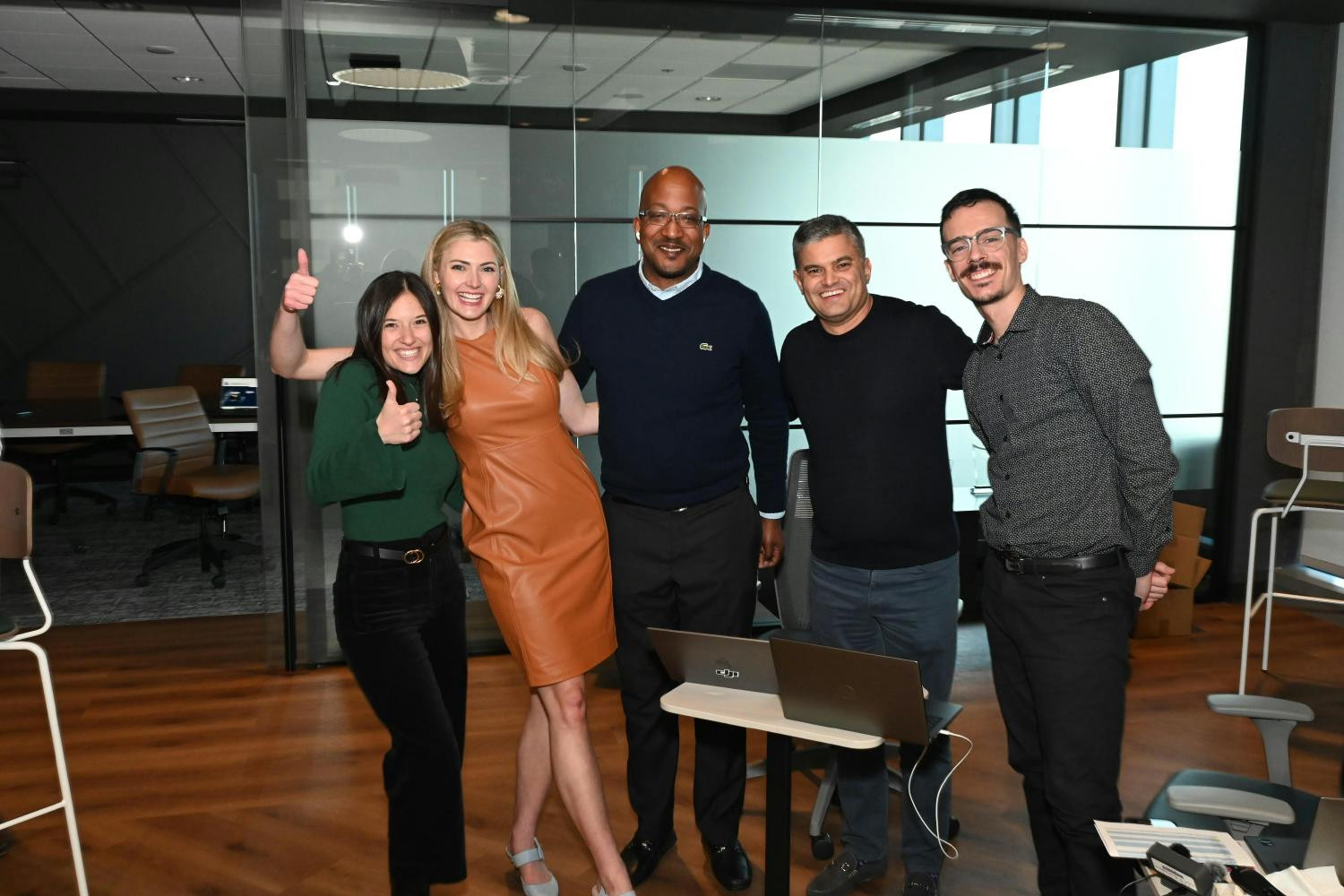 Team members gather for a picture to commemorate a successful live kickoff event. 