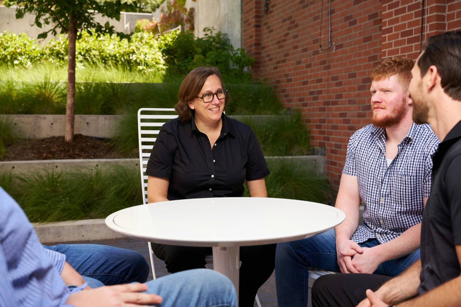 The team takes their daily standup meeting outside at our Colorado office.