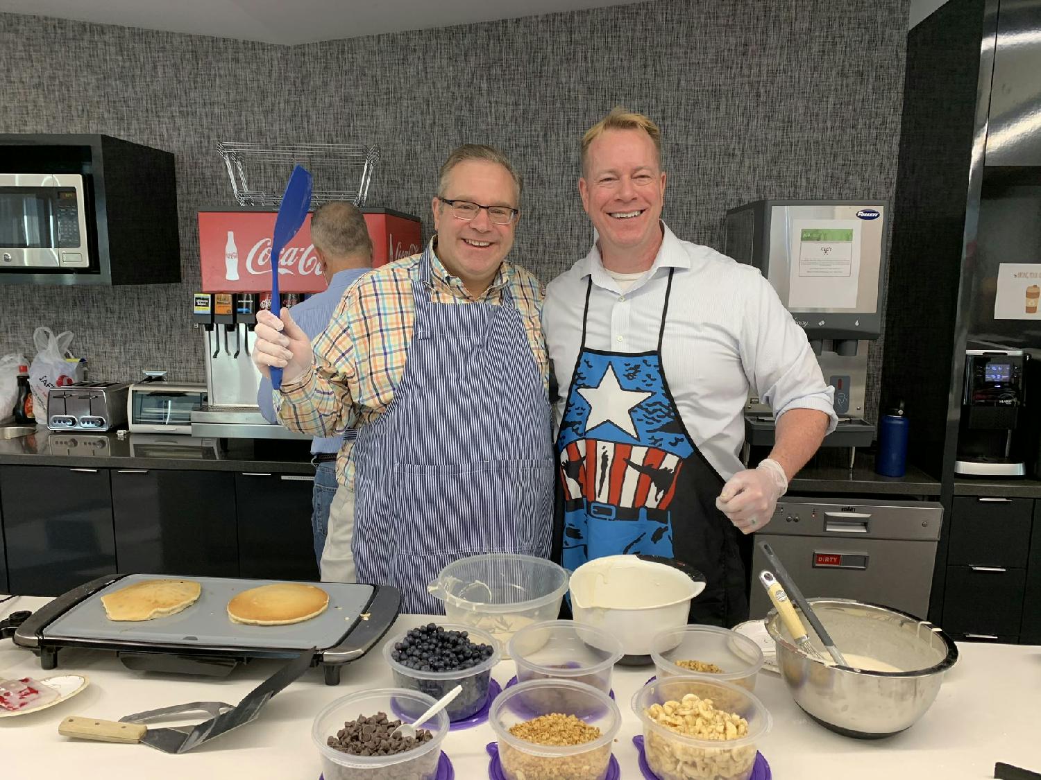 Blue Yonder leaders making breakfast for associates at corporate headquarters in Scottsdale, Arizona