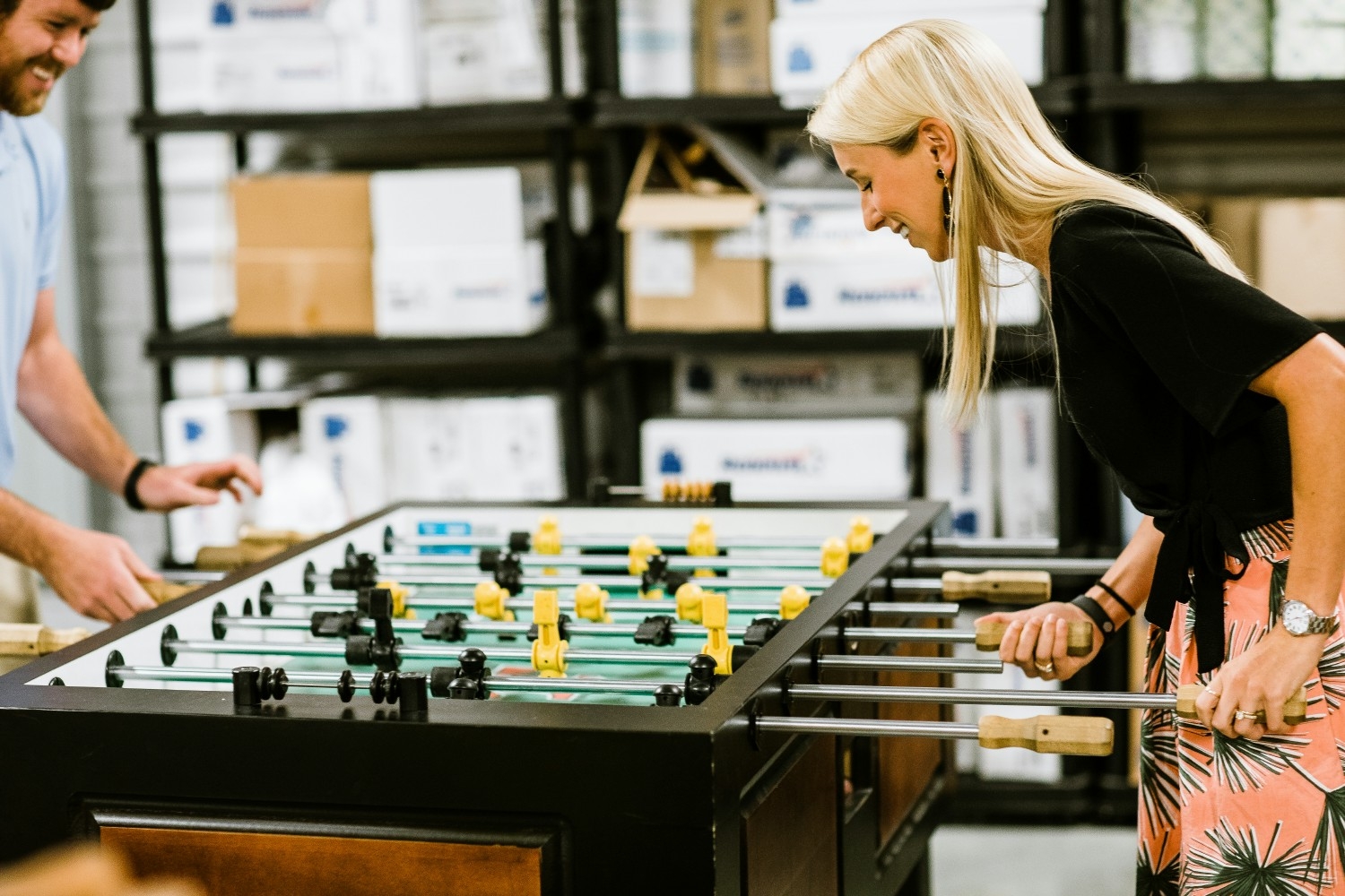 Big Ass Fans employees enjoy a game of foosball during lunch. 