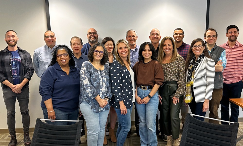 Employees gather for a team meeting at Purchase, NY headquarters.