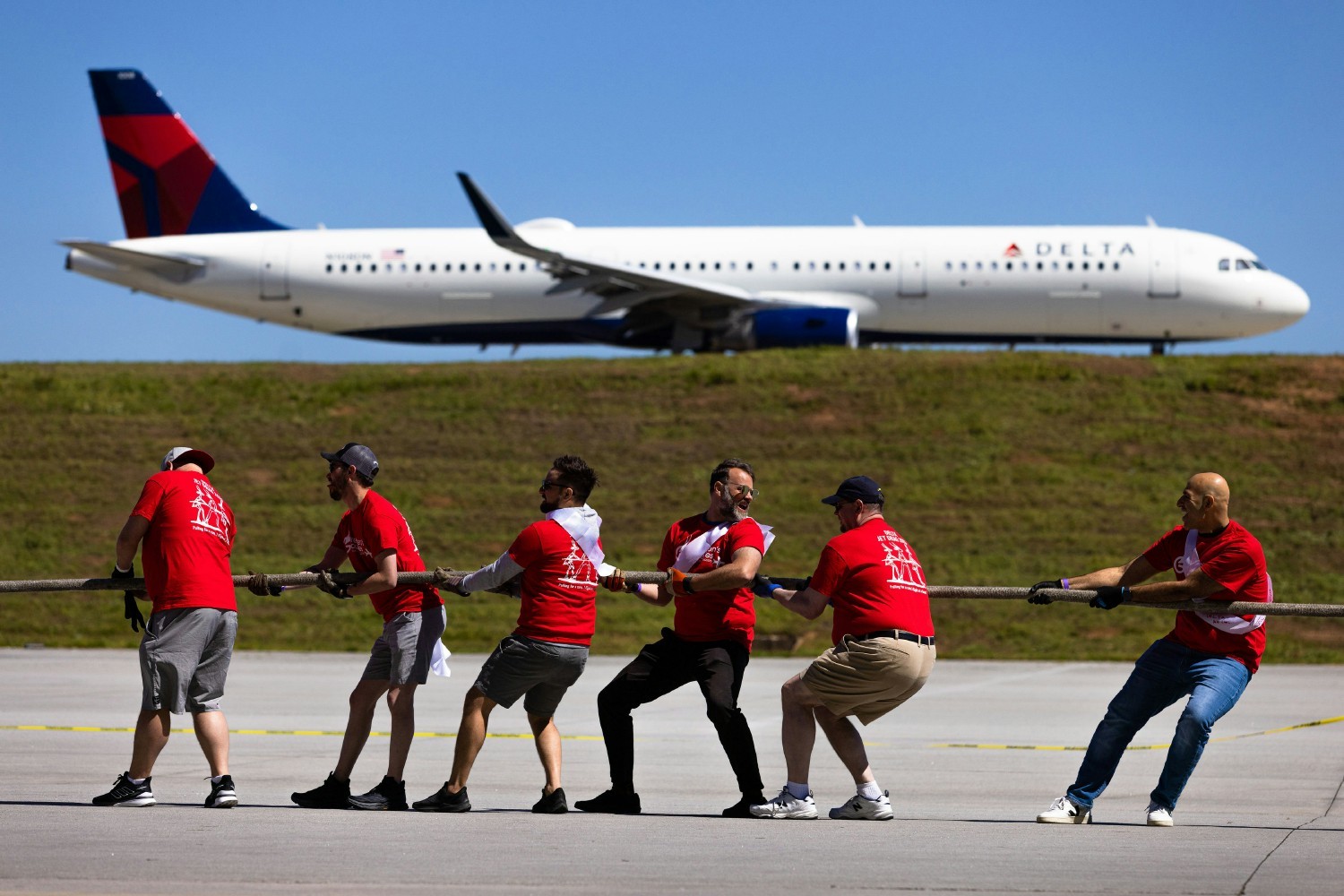 Employees at Jet Drag, a giant tug-of-war with a jet, to raise awareness and funds for the American Cancer Society.