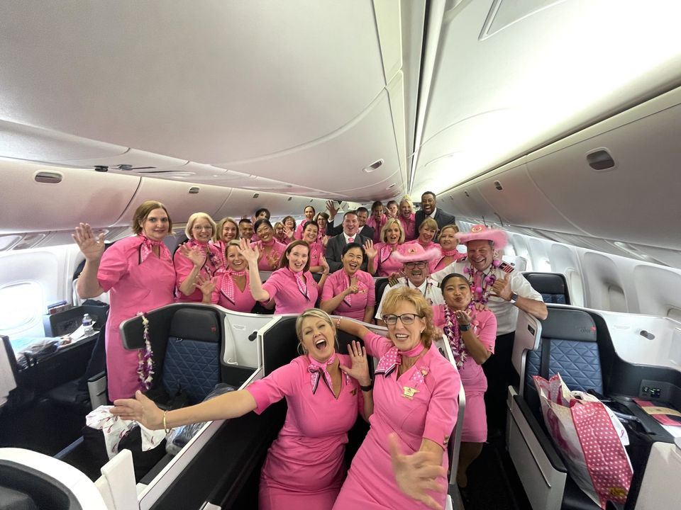 “Breast Cancer One” passengers celebrate ahead of their survivor charter flight.