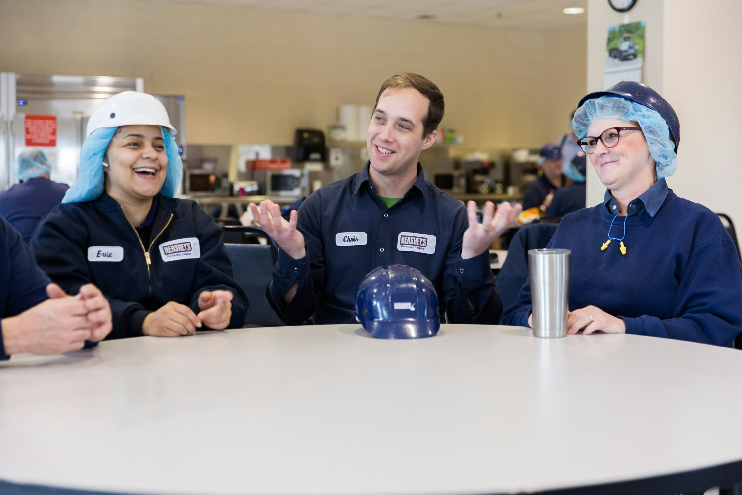 Manufacturing employees engaging in conversations