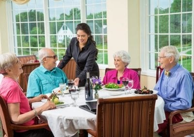 Culinary employee serving residents in our Dining Room.