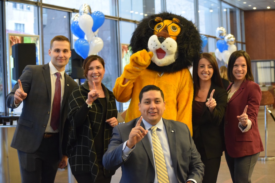 Hubert celebrating with a group of employees.