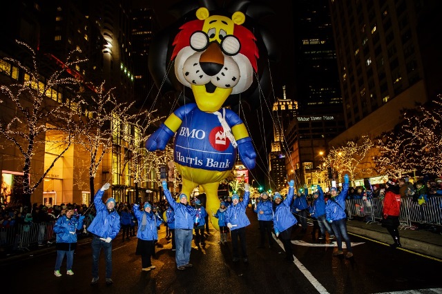  Employee volunteers lead Hubert T. Lion down the Mag Mile at the annual Light Festival 