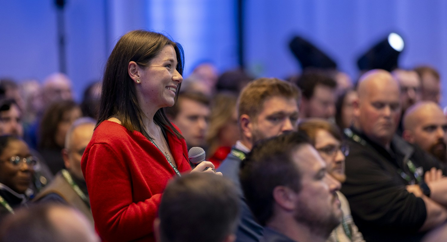 A Nucor teammate asks a question at company wide event demonstrating open communication, one of Nucor's core values