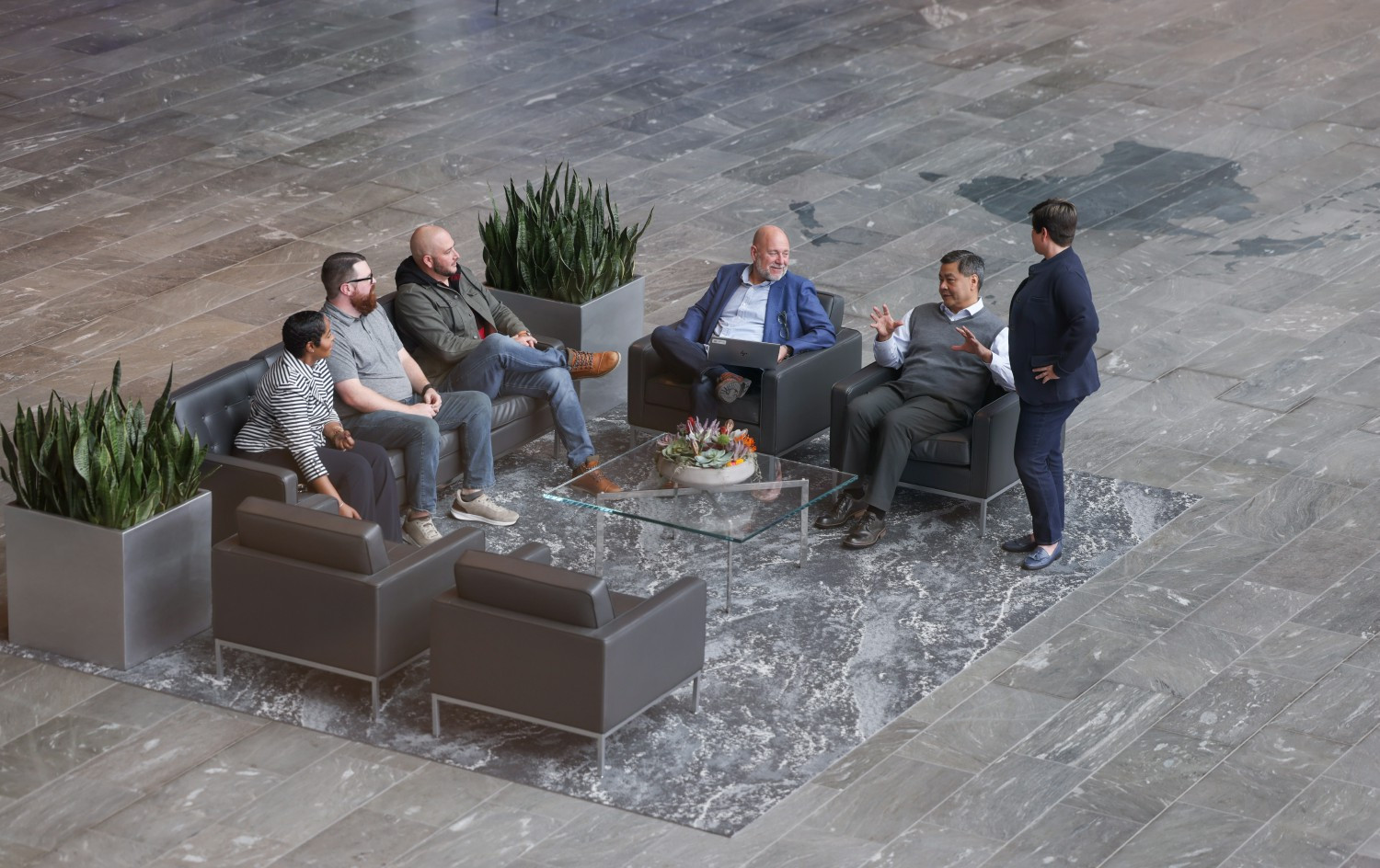 Employees meeting in Eaton Center lobby.