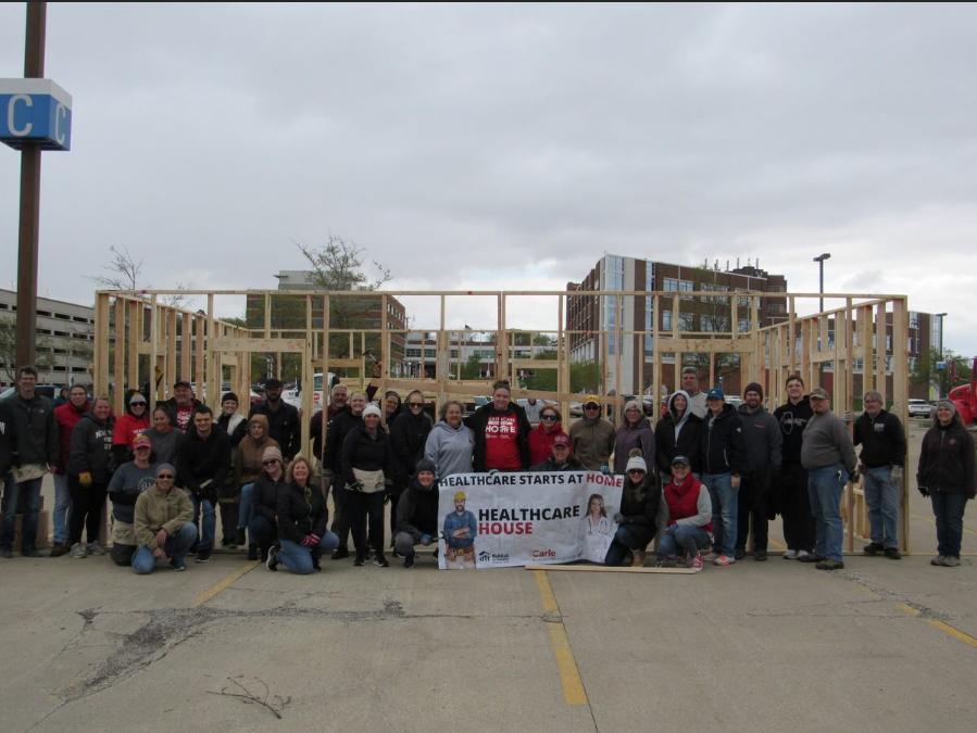 Carle Health volunteers help build the framework for a future Habitat for Humanity homeowner in one of our communities.