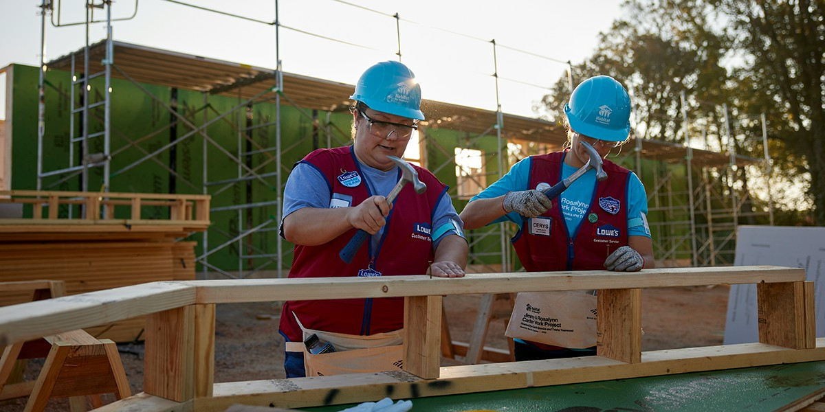 Associates participating in Jimmy and Rosalynn Carter Work Project for Habitat for Humanity.