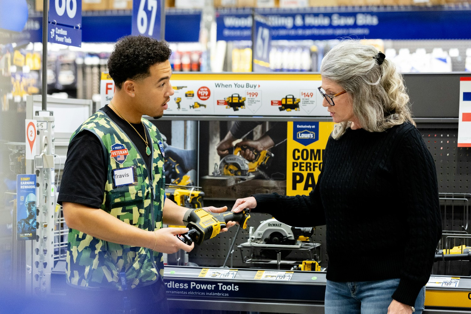 Store Associate in Tools assisting a customer choose the right power tool.