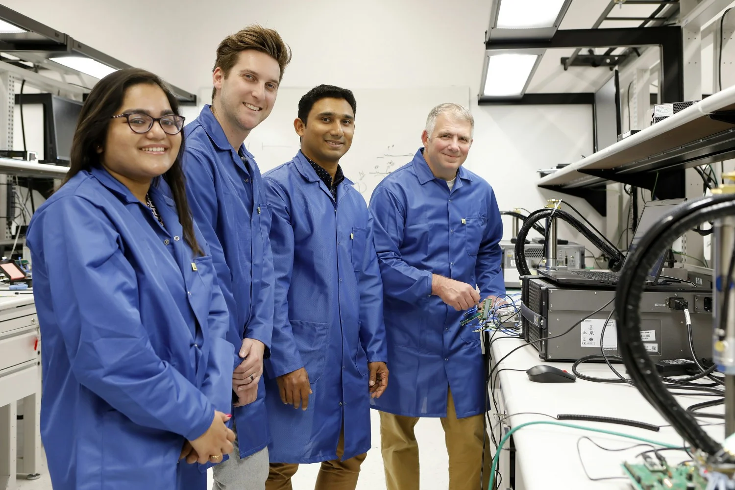 Cadence employees collaborating in the lab together. 