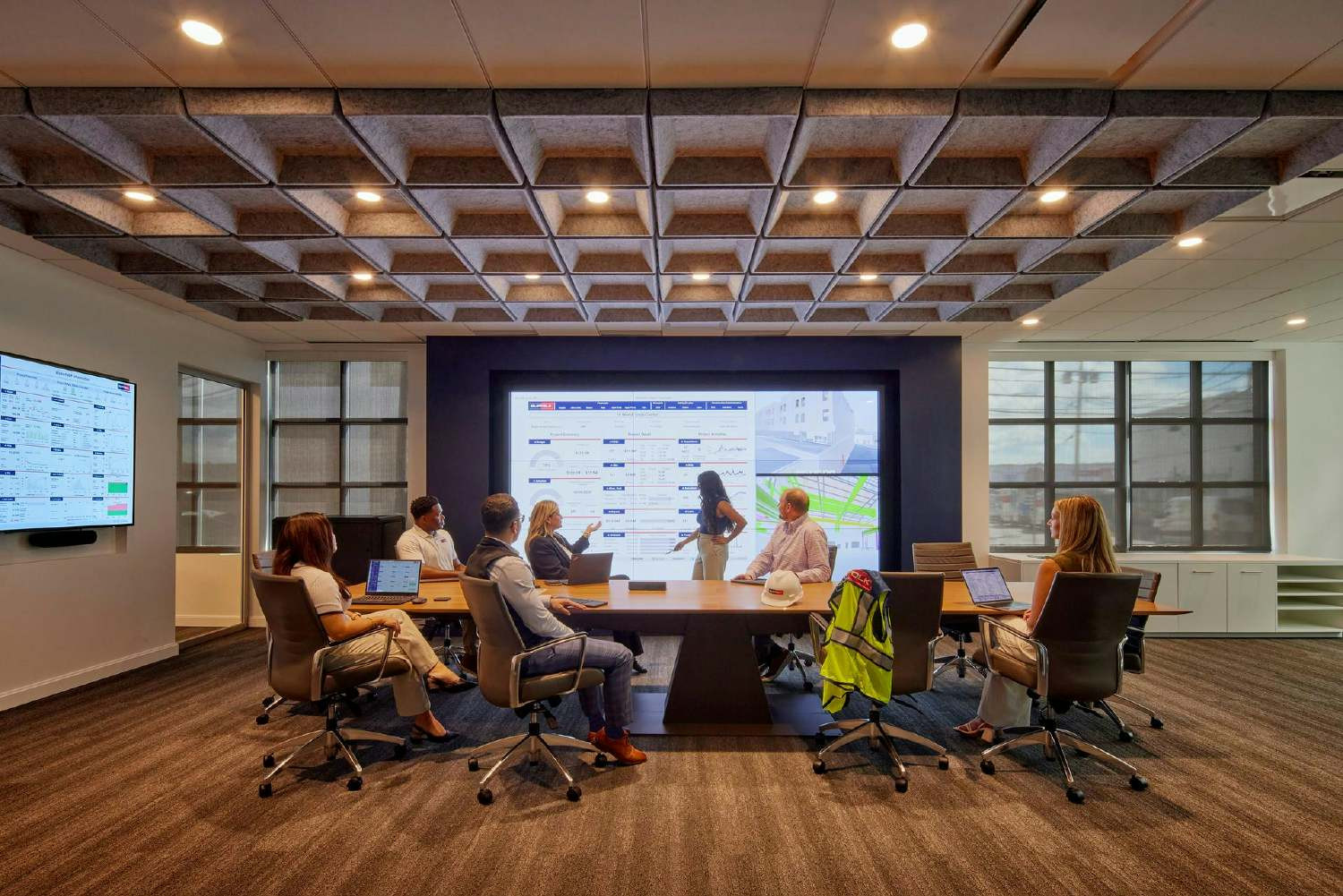 Boston team members view Suffolk’s data-driven dashboards, which provide visibility and transparency into our projects. 