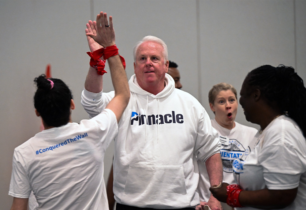 Pinnacle's CEO cheers on other associates during teambuilding day at a three-day orientation for all new associates.