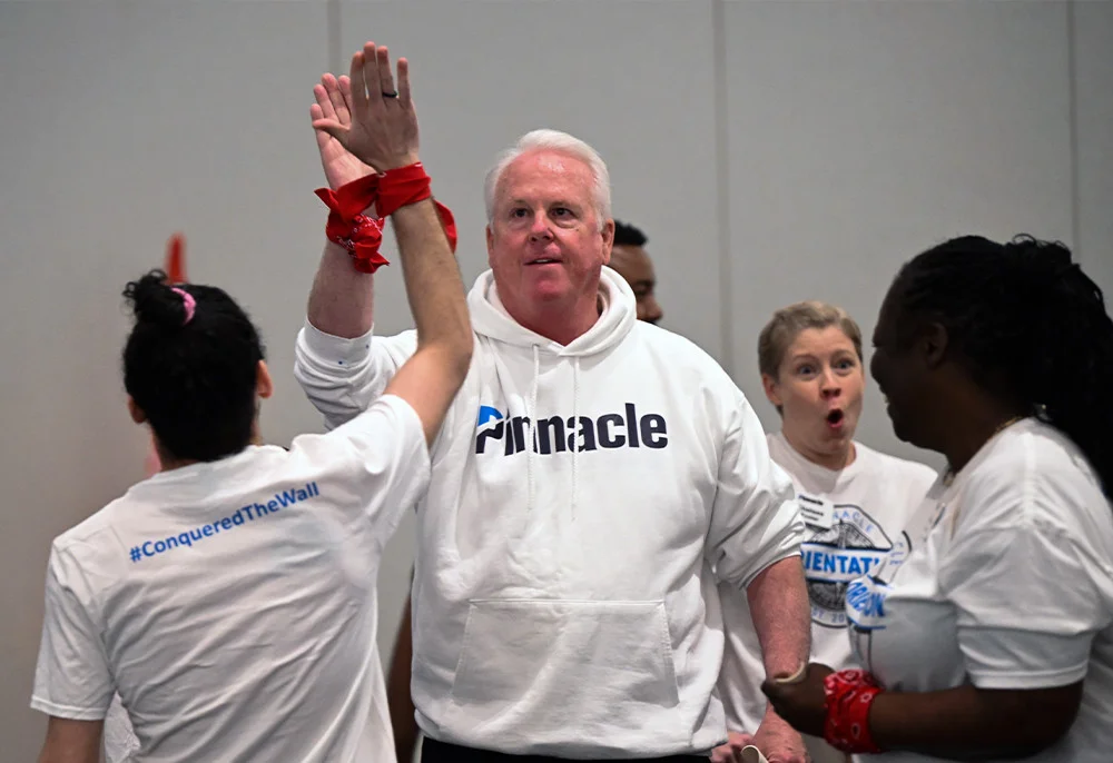 Pinnacle's CEO cheers on other associates during teambuilding day at a three-day orientation for all new associates.
