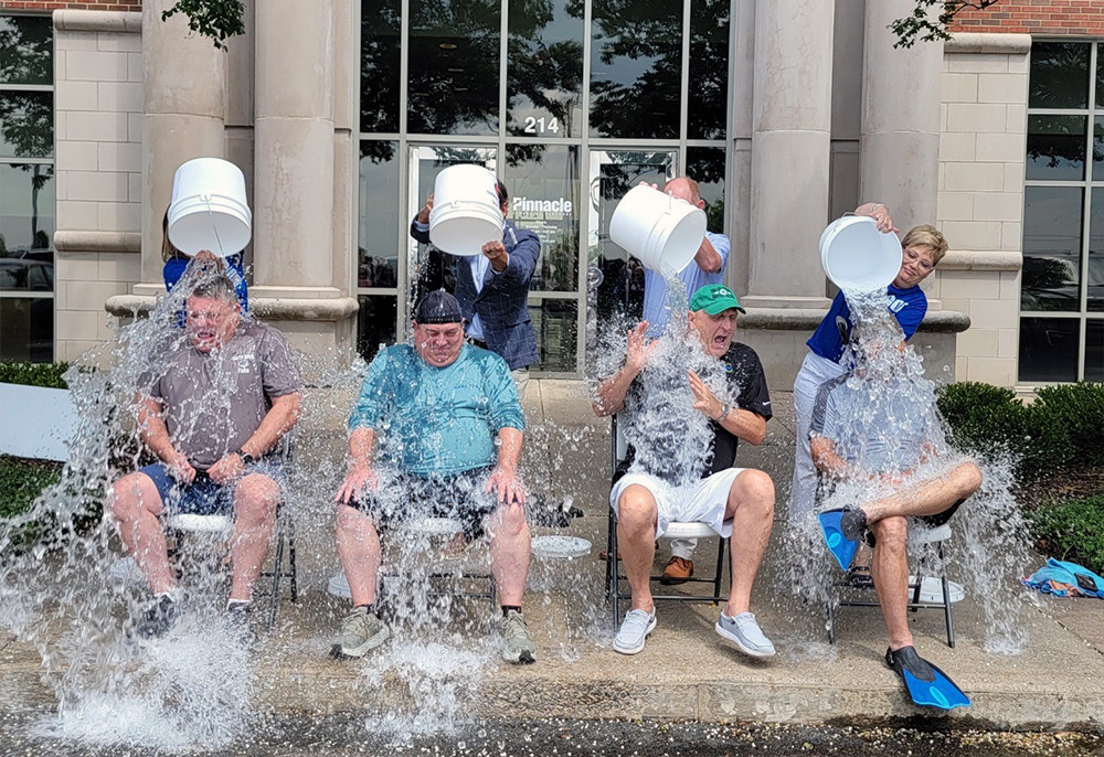 Pinnacle leaders get doused in an ice bucket challenge to support the ALS Foundation and an associate with ALS.