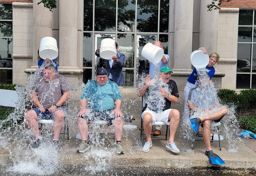 Pinnacle leaders get doused in an ice bucket challenge to support the ALS Foundation and an associate with ALS.