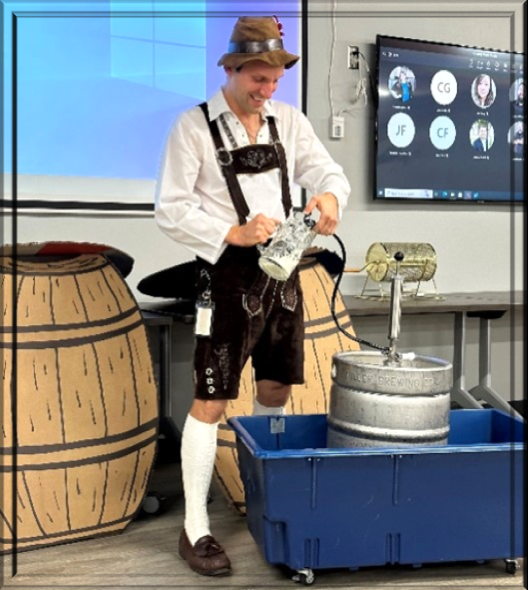 Miles, our CEO, taps a keg to celebrate the start of Oktoberfest and the accomplishment of a company wide goal. 