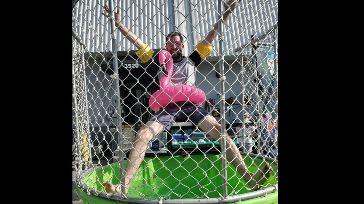 Abe, Senior Trainer, wears some important PPE as he waits for a splash in the dunk tank! 