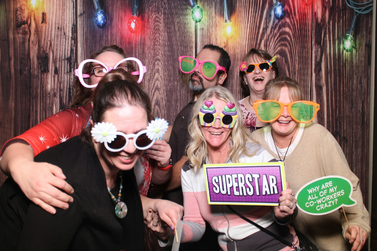 Team members celebrate during our companywide party while taking advantage of the photo booth!