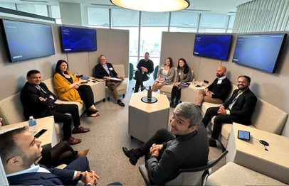 Employees enjoy our modern, tech enabled workspace at our HQ to host a team meeting.