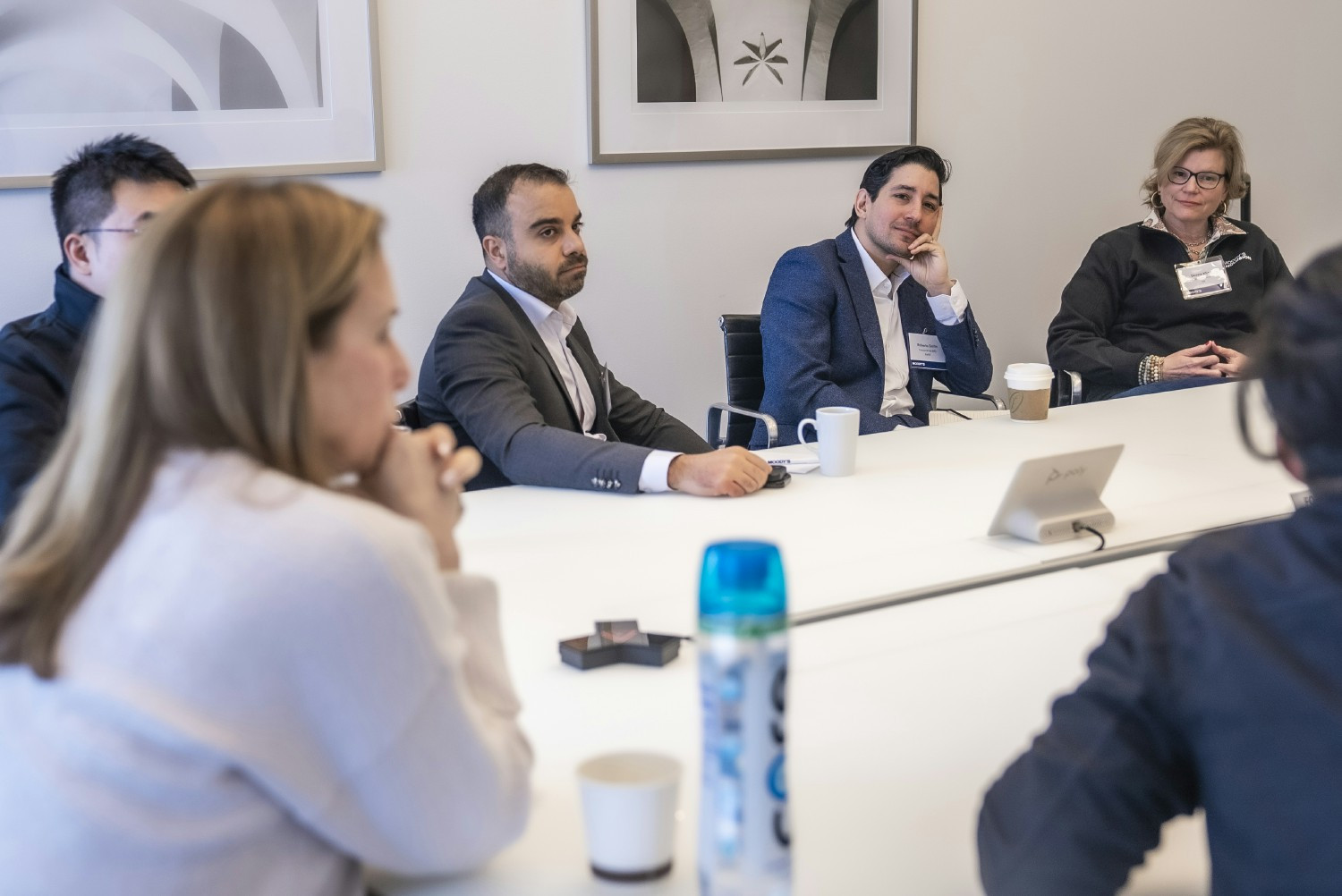 Moody's employees meet in NYC at the newly redesigned World Trade Center 52nd floor office.