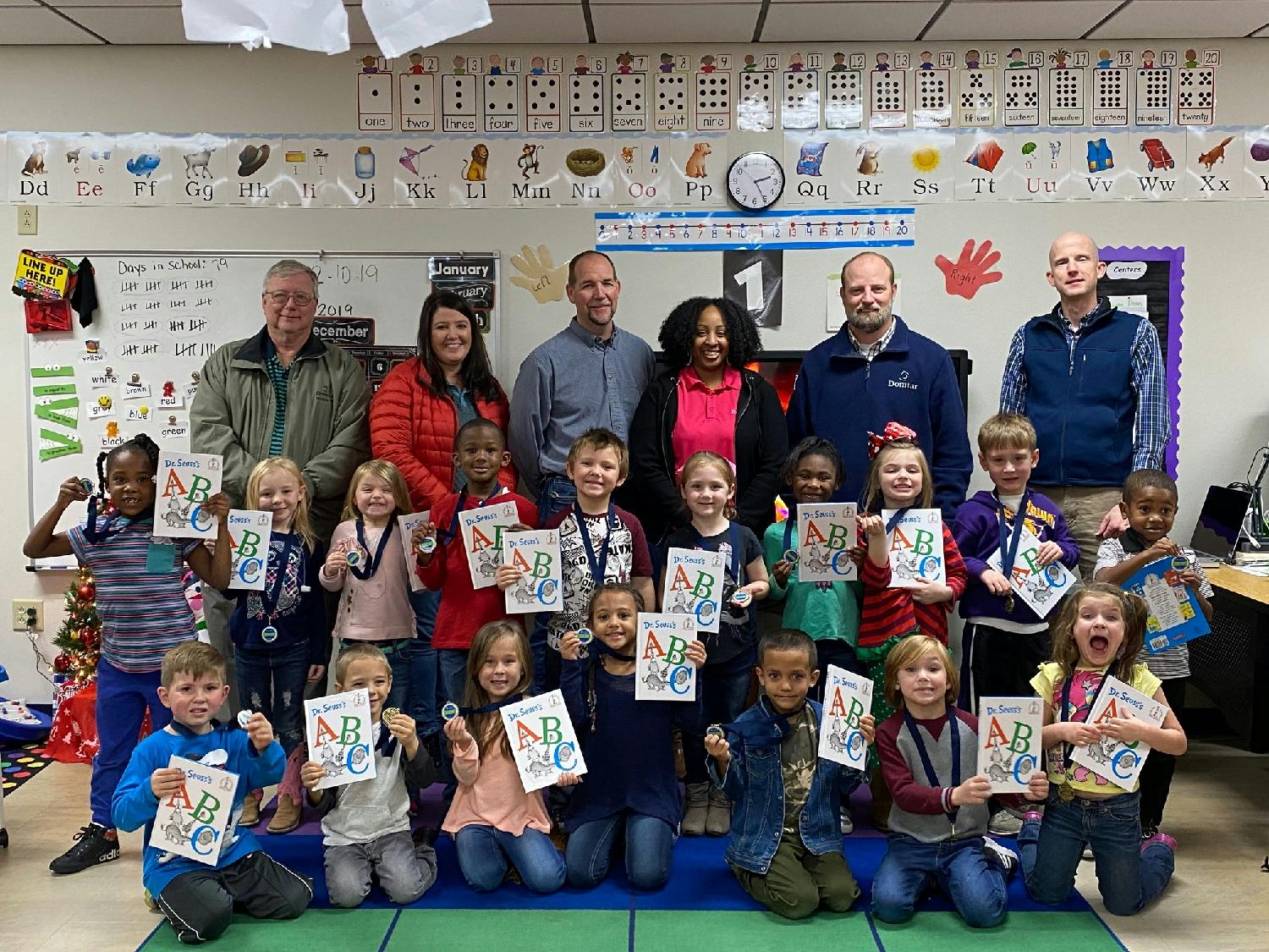 Employees from our mill in Ashdown, AR, visit a local school for a First Book reading event, where each child receives a book of their own at the end.