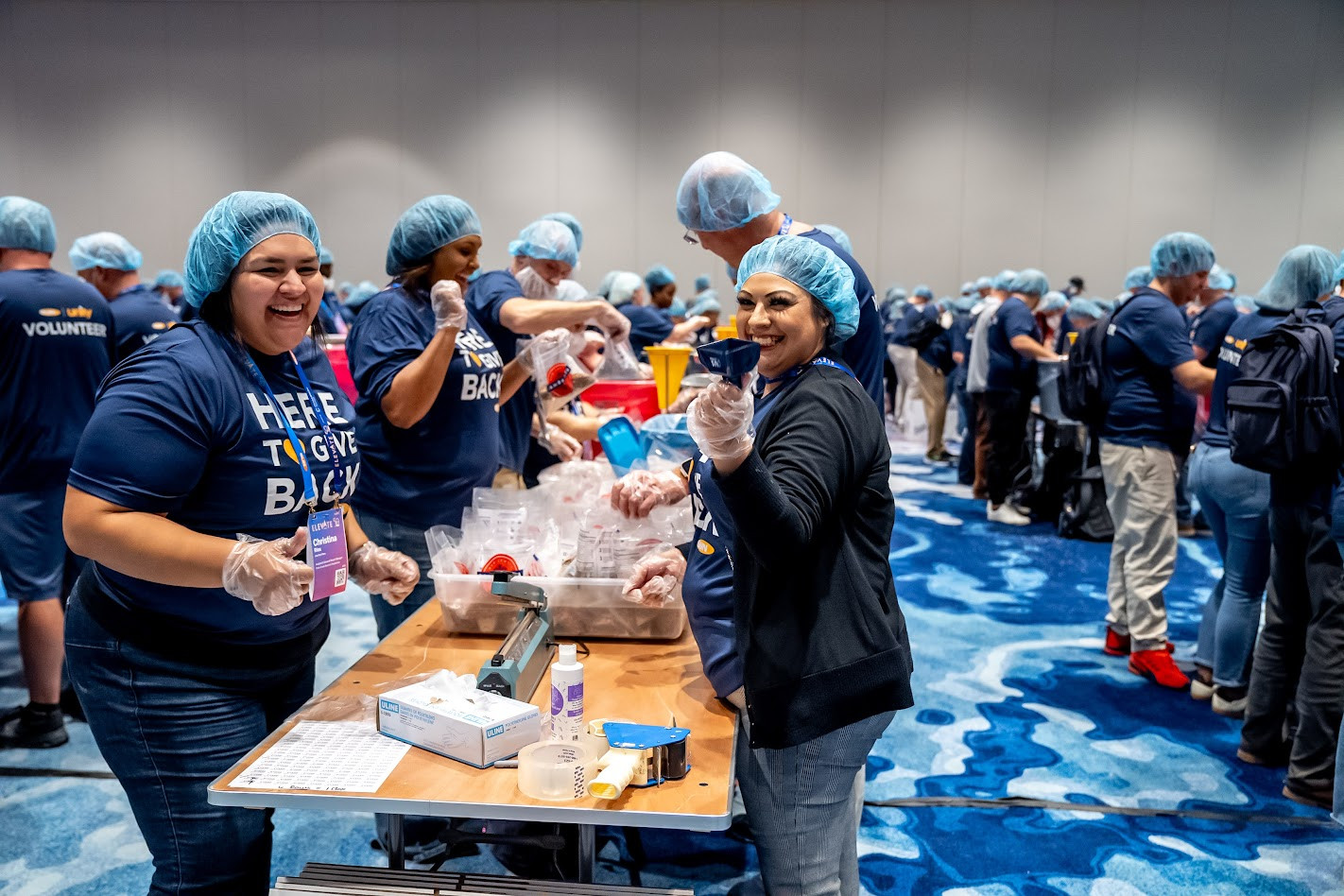 Giving back to the communities we live and work in is core to who we are. All smiles while packing meals with US Hunger.
