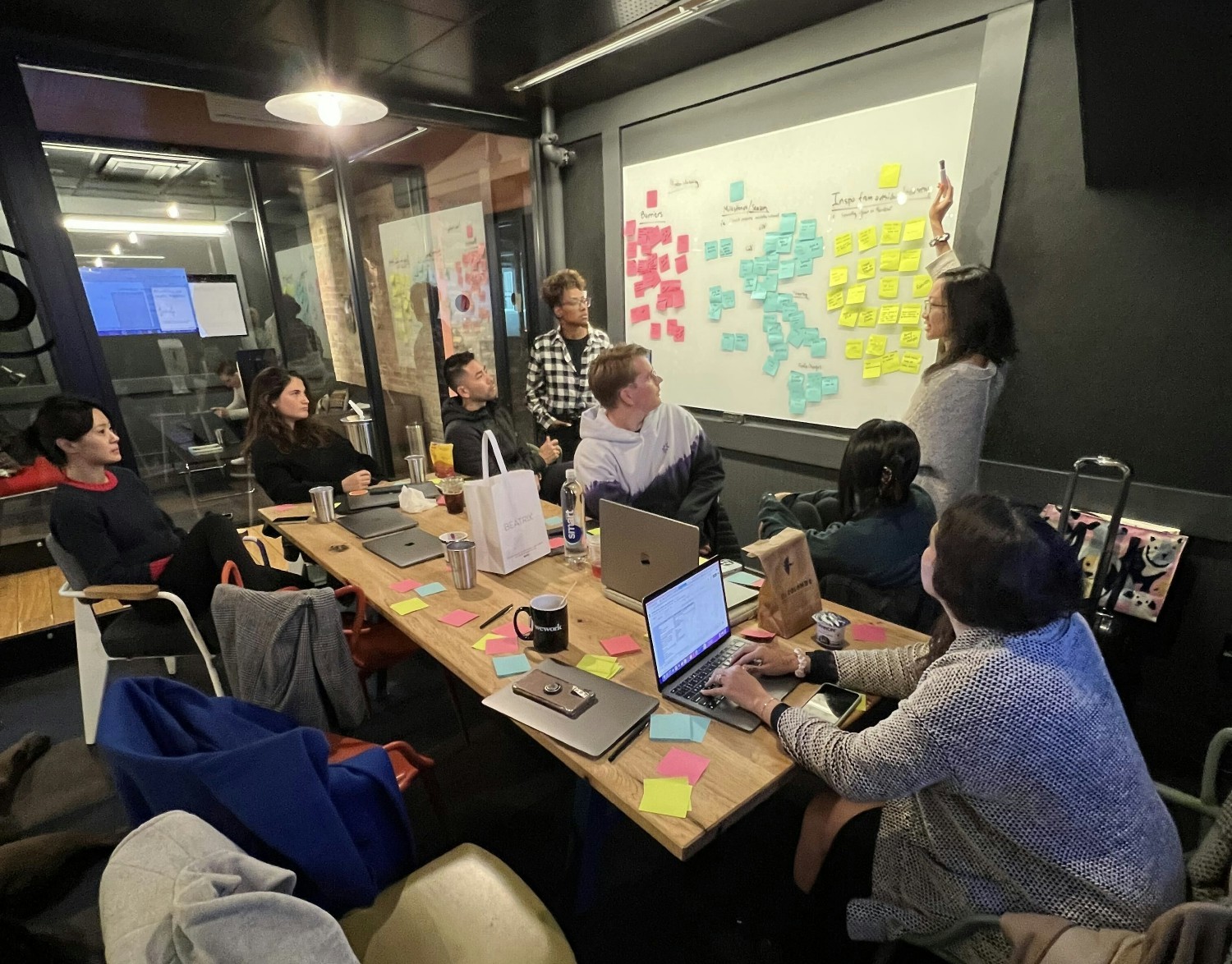 Brightline team working in-person at a temporary shared workspace. 