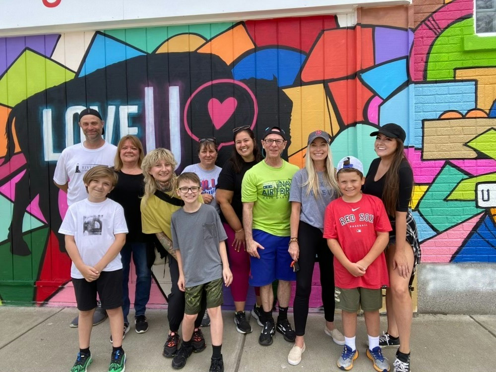Our Buffalo team volunteering for a block clean-up to unveil a mural dedicated to mental health.