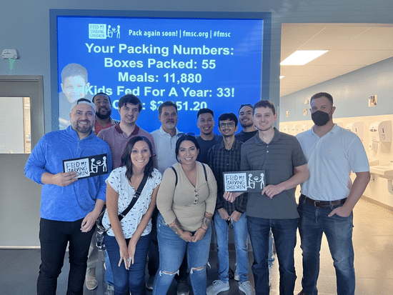 Members of our Chicago team volunteering for Feed my Starving Children